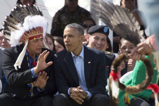 US President Barack Obama (C) talks with Chairman of the Standing Rock Soiux Tribal Nation David Archambault II (L) during the Cannon Ball Flag Day Celebration in Cannon Ball, North Dakota, June 13, 2014.